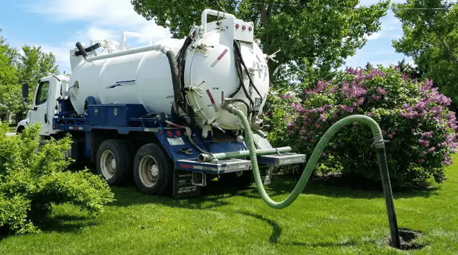 Professional vacuum truck performing residential drainage and septic maintenance in Long Beach, CA