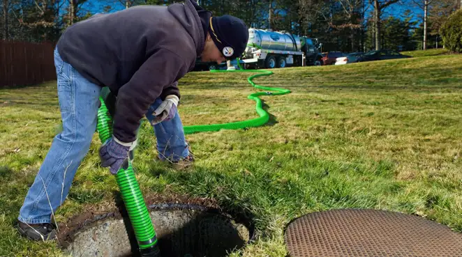 Service technician performing residential septic pumping and drainage maintenance in Long Beach, CA